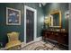 Elegant powder room features dark green walls, custom flooring, and an ornate gold mirror at 7046 N 59Th Pl, Paradise Valley, AZ 85253