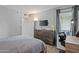 Bedroom featuring a TV, dresser, lamps, queen sized bed, a desk, a chair, and access to a balcony at 7625 E Camelback Rd # A114, Scottsdale, AZ 85251