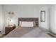 Bedroom with wood-look floors, queen bed, and decorative mirror on wall at 7625 E Camelback Rd # A114, Scottsdale, AZ 85251