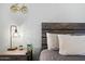 Bedroom features a side table with lamp, soft lighting, and wall decor at 7625 E Camelback Rd # A114, Scottsdale, AZ 85251