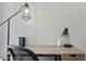 Close-up on a desk with a metal frame, drawers, two lamps, a mesh chair, and a router at 7625 E Camelback Rd # A114, Scottsdale, AZ 85251
