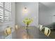 Modern dining room featuring a metal table with seating for four and a light fixture above at 7625 E Camelback Rd # A114, Scottsdale, AZ 85251