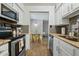 Modern kitchen featuring stainless steel appliances, granite counters, and view into dining area at 7625 E Camelback Rd # A114, Scottsdale, AZ 85251