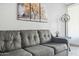 Close up of a comfortable gray sofa with decorative pillows and nearby table with a lamp at 7625 E Camelback Rd # A114, Scottsdale, AZ 85251