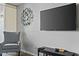 Comfortable armchair with a black TV stand and large, flatscreen television on the wall at 7625 E Camelback Rd # A114, Scottsdale, AZ 85251