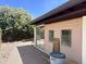 View of backyard featuring a stone walkway, pink building, and a lush, mature tree providing ample shade at 8552 E Vía Del Palacio --, Scottsdale, AZ 85258