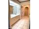 Bathroom featuring double sinks, a large mirror, and a shower visible through an open doorway at 8552 E Vía Del Palacio --, Scottsdale, AZ 85258