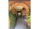 Charming front entrance featuring a brick archway and tiled porch, creating an inviting welcome at 8552 E Vía Del Palacio --, Scottsdale, AZ 85258