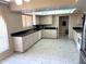 Spacious kitchen with white cabinets, black countertops, and tiled flooring at 8552 E Vía Del Palacio --, Scottsdale, AZ 85258