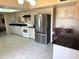 Bright kitchen with white cabinets, stainless steel refrigerator, and black countertops at 8552 E Vía Del Palacio --, Scottsdale, AZ 85258
