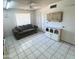 Living room boasts neutral colors, tiled floors, large window with blinds, and convenient access to an adjacent room at 8552 E Vía Del Palacio --, Scottsdale, AZ 85258