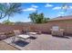Comfortable brick patio with grill, chairs, and a fireplace is perfect for outdoor enjoyment at 8817 S 13Th Way, Phoenix, AZ 85042