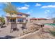 Expansive backyard showcasing outdoor seating, a fireplace, and landscaped surroundings for outdoor enjoyment at 8817 S 13Th Way, Phoenix, AZ 85042
