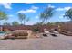Backyard featuring a fireplace, patio, and landscaped surroundings for outdoor enjoyment at 8817 S 13Th Way, Phoenix, AZ 85042