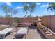 Backyard featuring a fireplace, patio, and landscaped surroundings for outdoor enjoyment at 8817 S 13Th Way, Phoenix, AZ 85042