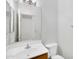 Compact bathroom featuring a white sink, toilet, vanity, and light fixtures at 8817 S 13Th Way, Phoenix, AZ 85042