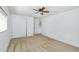 Cozy bedroom with a large closet, neutral carpet, ceiling fan, and a door leading to the bathroom at 8817 S 13Th Way, Phoenix, AZ 85042