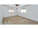 Bright bedroom featuring neutral carpet, ceiling fan, and two windows with wood blinds at 8817 S 13Th Way, Phoenix, AZ 85042