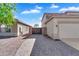 Paver driveway leads to a gated entrance and a two-car garage on a sunny day at 8817 S 13Th Way, Phoenix, AZ 85042