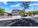 Two-story home with a three car garage, desert landscaping, and a tile roof set against a blue sky at 8817 S 13Th Way, Phoenix, AZ 85042