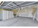 Spacious garage with ample storage cabinets, workbench, and high ceilings at 8817 S 13Th Way, Phoenix, AZ 85042