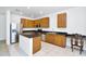 Well-lit kitchen featuring wood cabinets, stainless steel appliances, and a granite-topped island at 8817 S 13Th Way, Phoenix, AZ 85042