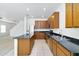 Spacious kitchen with wood cabinetry, granite countertops, and stainless steel appliances at 8817 S 13Th Way, Phoenix, AZ 85042