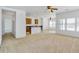 An expansive living space with a ceiling fan leading to a kitchen with tile floors at 8817 S 13Th Way, Phoenix, AZ 85042