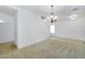 Open living space with neutral carpet, ample natural light, and an elegant chandelier at 8817 S 13Th Way, Phoenix, AZ 85042