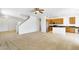Open floorplan living space that flows to a kitchen with stainless appliances and wood cabinets at 8817 S 13Th Way, Phoenix, AZ 85042