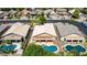 Aerial view of a home featuring a private pool and covered patio, surrounded by lush landscaping in a well-maintained neighborhood at 9511 E Kiva Ave, Mesa, AZ 85209