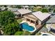 Aerial view of a home featuring a refreshing pool, covered patio, and lush landscaping in a desirable neighborhood at 9511 E Kiva Ave, Mesa, AZ 85209