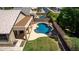 Aerial view showcasing a private backyard with a refreshing pool, outdoor patio, and lush landscaping at 9511 E Kiva Ave, Mesa, AZ 85209