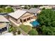 Aerial view of home featuring a refreshing pool, covered patio, and well-maintained landscaping at 9511 E Kiva Ave, Mesa, AZ 85209