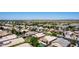 Expansive aerial view showcasing a neighborhood with well-maintained homes, landscaping, and community spaces against a desert backdrop at 9511 E Kiva Ave, Mesa, AZ 85209