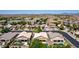 This aerial view captures a suburban neighborhood with neatly arranged homes, each featuring desert landscaping and private backyard pools at 9511 E Kiva Ave, Mesa, AZ 85209