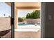 Covered patio view to the backyard swimming pool with rock waterfall feature at 9511 E Kiva Ave, Mesa, AZ 85209