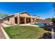 Backyard oasis featuring a private pool, covered patio, and a well-manicured lawn perfect for entertaining at 9511 E Kiva Ave, Mesa, AZ 85209