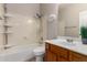A cozy bathroom featuring a shower-tub combo, vanity sink, and gray walls at 9511 E Kiva Ave, Mesa, AZ 85209
