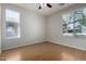 Bedroom features hardwood floors, a ceiling fan, and two large windows at 9511 E Kiva Ave, Mesa, AZ 85209