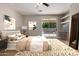 Cozy bedroom features a plush bed, sliding glass doors to the pool, and neutral decor for a relaxing retreat at 9511 E Kiva Ave, Mesa, AZ 85209