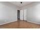 Bedroom with hardwood floors, gray walls, ceiling fan, and a door to the hallway at 9511 E Kiva Ave, Mesa, AZ 85209
