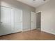 Bedroom featuring hardwood floors and large closet doors at 9511 E Kiva Ave, Mesa, AZ 85209