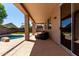 Spacious covered patio with comfortable seating, overlooking lush backyard landscaping at 9511 E Kiva Ave, Mesa, AZ 85209