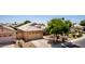 Home featuring a well-manicured front yard, complemented by desert landscaping and a spacious driveway at 9511 E Kiva Ave, Mesa, AZ 85209