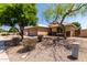Single-story home with a two-car garage, xeriscaped yard, and stone accents visible from the street at 9511 E Kiva Ave, Mesa, AZ 85209
