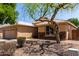 Single-story home with a two-car garage, xeriscaped yard, and stone accents viewed from the side at 9511 E Kiva Ave, Mesa, AZ 85209
