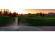 Scenic view of the golf course at sunset with lush green fairways and a tranquil water feature at 9511 E Kiva Ave, Mesa, AZ 85209