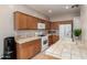 Charming kitchen with tile counters and white appliances at 9511 E Kiva Ave, Mesa, AZ 85209