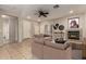 Comfortable living room featuring a fireplace, neutral tones, and ample seating for relaxing and entertaining at 9511 E Kiva Ave, Mesa, AZ 85209